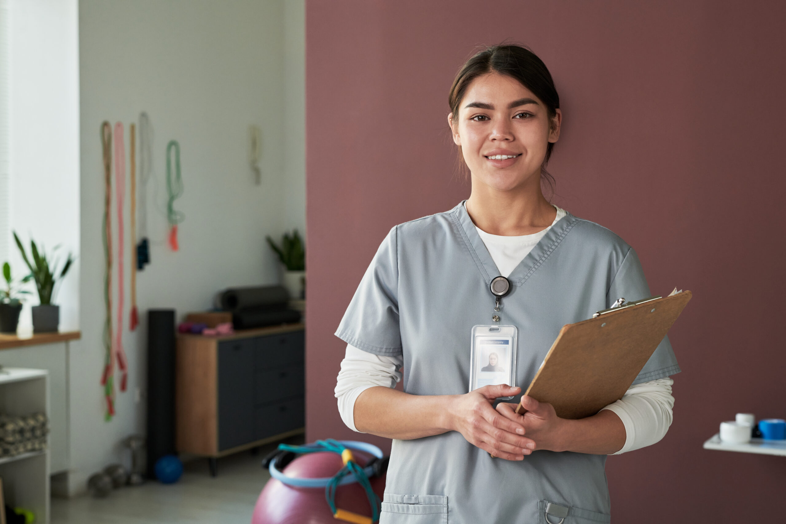 Portrait of Female Nurse Smiling and Holding Clipboard